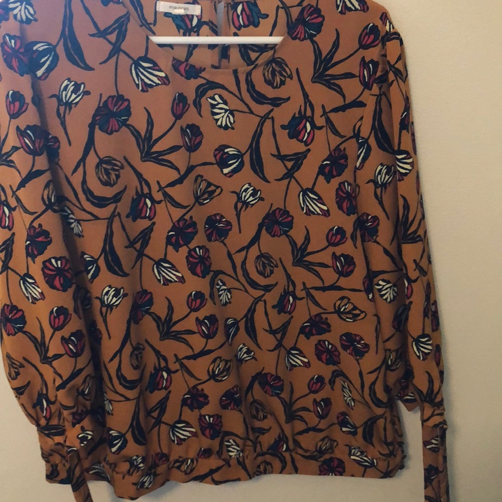 Mustard-color floral blouse, with flowers.